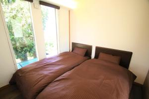 A bed or beds in a room at オザッキー大室高原4丁目
