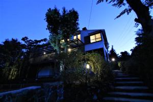 a building with stairs leading up to it at night at オザッキー大室高原4丁目 in Futo