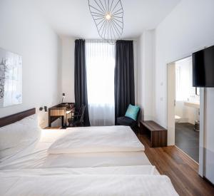 Postel nebo postele na pokoji v ubytování acor Boutique Hotel