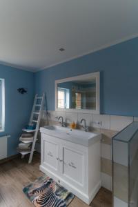 a bathroom with a sink and a mirror at Blanks Safari Lodge in Klein Schwaß