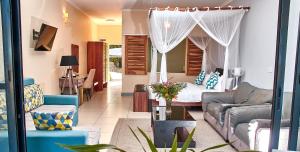 a living room with a couch and a bed at Lake Kariba Inns in Siavonga