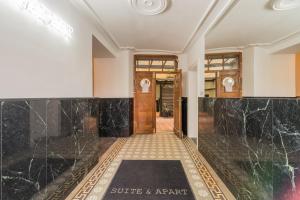 a lobby with black marble walls and a door at SUITE & APART in Berlin