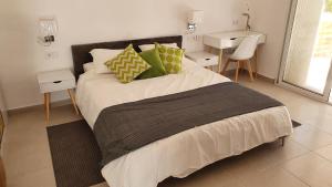 a bedroom with a large bed with two night stands at Casa Rainbow - Boutique Bed & Breakfast in Mojácar