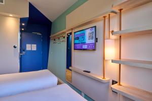 A television and/or entertainment centre at Ibis Budget Nangy Annemasse