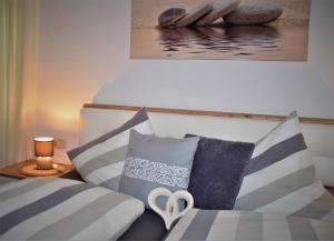 a bedroom with a bed with pillows and a painting at Ferienwohnungen Geiger in Bodenmais