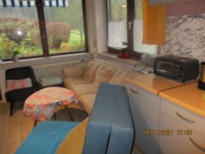 a living room with a couch and a table at Ferienwohnung Troglauer in Letzau