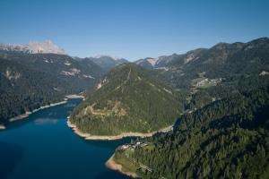an aerial view of a lake in the mountains at Casa Sauris in Sauris