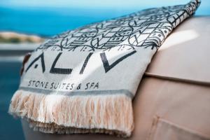 a pillow with the word lan on it sitting on a bench at Aliv stone suites & spa in Agios Nikolaos