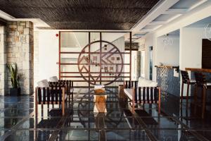 a room with chairs and a table and a sign at Aliv stone suites & spa in Agios Nikolaos
