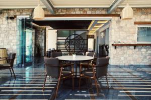 a dining room with a table and chairs at Aliv stone suites & spa in Agios Nikolaos