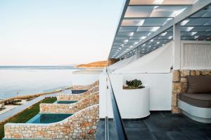 a view of the water from the balcony of a house at Aliv stone suites & spa in Agios Nikolaos