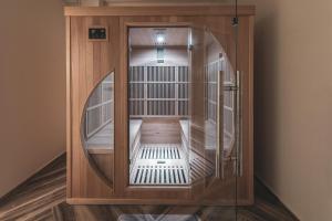 a wooden cage with a mirror in a room at Aliv stone suites & spa in Agios Nikolaos