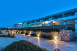 a building with lights on the side of it at Aliv stone suites & spa in Agios Nikolaos