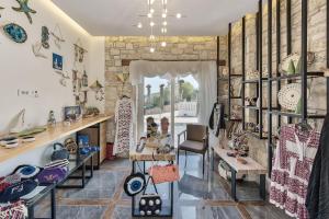a room with shelves of ceramics on the wall at Aliv stone suites & spa in Agios Nikolaos