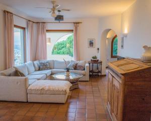 een woonkamer met een bank en een tafel bij Casa Inca, Villa with heatable pool and top view atop Moraira El Portet in Cumbre del Sol