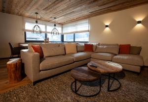 a living room with a couch and a table at Nova Gosta Montafon NEU in Gaschurn