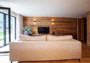 a living room with a couch and a tv at Nova Gosta Montafon NEU in Gaschurn