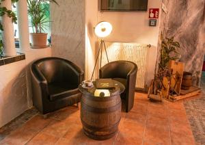 two chairs and a table and a lamp in a room at Waldgasthaus am Schwarzenbruch in Allenbach