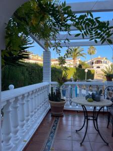 a balcony with a white fence and a table at Casa Flora - Mijas Costa - Andalusië in Mijas