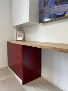 a cabinet with a television on top of it at Start Apartments 2 in Bucharest