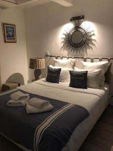 a bedroom with a large bed with a mirror on the wall at Maxima Sunset in Sainte-Maxime