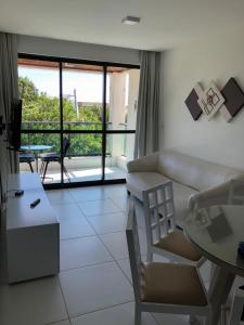 a living room with a couch and a table at ILOA RESIDENCE L202 in Barra de São Miguel