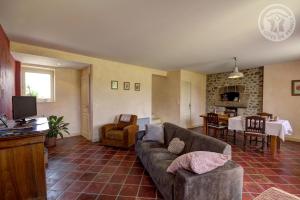 a living room with a couch and a table at Chambres d'Hôtes Ondine et Igor in Saint-Marcellin-en-Forez