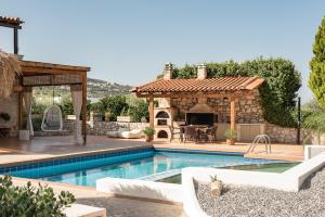 a pool with a gazebo and a house at Agnes Villa, unrivalled living, By ThinkVilla in Pigi