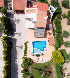 an aerial view of a house with a swimming pool at Agnes Villa, Unrivalled Living with Private Pool, By ThinkVilla in Pigi