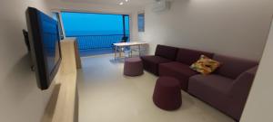 a living room with a couch and a flat screen tv at jacuzzi & sauna apartment ! in Salou