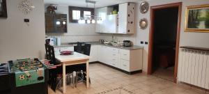 a kitchen with white cabinets and a table in it at New Home in Ferno