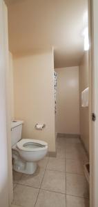 a bathroom with a toilet and a tiled floor at Lakeview Inn & Suites Okeechobee in Okeechobee