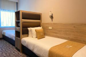 
A bed or beds in a room at XO Hotels Blue Square
