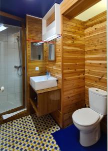a bathroom with a white toilet and a sink at Quinta da Meia Eira in Horta