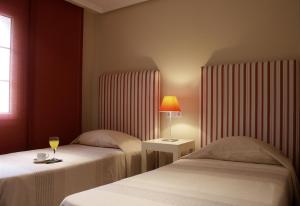 Postel nebo postele na pokoji v ubytování Ducado Real