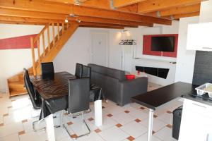 a living room with a dining room table and a couch at Songe de Thau in Balaruc-le-Vieux