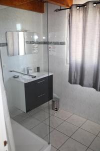 a bathroom with a sink and a glass shower at Songe de Thau in Balaruc-le-Vieux