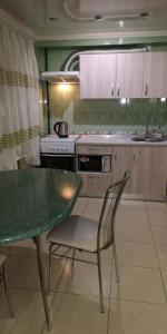 a kitchen with a table and a table and chairs at Уютная квартира возле CITY Mall in Zaporozhye