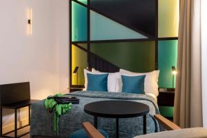 a hotel room with a bed and a table at Le 12 Hôtel in Paris