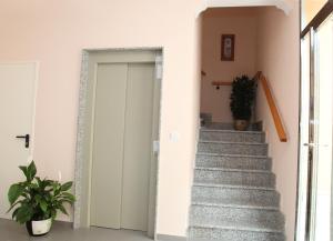eine Treppe in einem Haus mit einer Tür und einer Pflanze in der Unterkunft Hostal Avenida in Tabernas