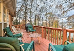 a deck with chairs and tables on a house at Lake Barkley Home with Fire Pit and Private Dock! in Cadiz