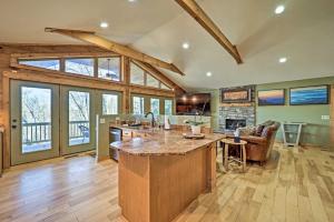 an open kitchen with a large island in a house at Peaceful Banner Elk Mountain Cabin Near Ski Areas! in Banner Elk