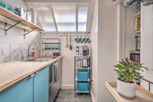 a kitchen with blue cabinets and a sink at Boston Apartment Walk to Beach and 2 Mi to Downtown in Boston