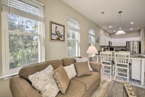 a living room with a couch and a kitchen at Modern Escape in the Heart of Murrells Inlet in Myrtle Beach