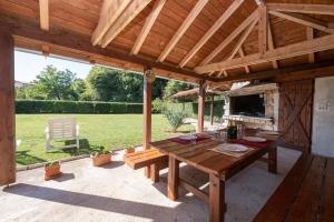 a wooden patio with a table and a stove at Apartment Lara in Lovran