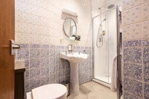 a bathroom with a sink and a toilet and a shower at Ees Wyke Country House in Near Sawrey +108 photos