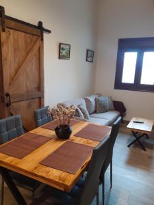 a dining room with a wooden table and a couch at A Nosa Casa 2 in Belesar +23 photos