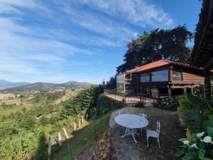 a table and chairs in front of a house at Eco Hotel Ixhi in Pátzcuaro