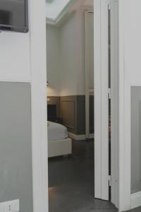 a room with a bedroom with a bed and a tv at WE LOVE ROMA Guest House in Rome