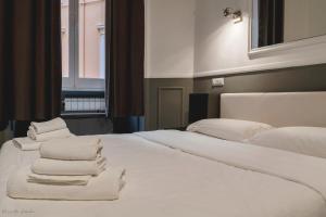 a bedroom with two beds with white towels on them at WE LOVE ROMA Guest House in Rome